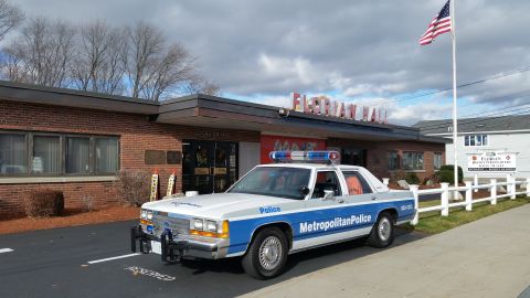 1991 Ford LTD Crown Victoria - Photo of a blue-and-white Metropolitan Police Crown Victoria parked outside Florian Hall, not a technical document.