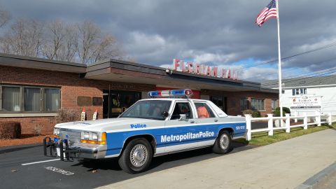 1991 Ford LTD Crown Victoria - Photo of a Metropolitan Police Crown Victoria police car in a parking lot, not a technical document.