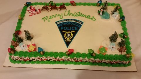 1991 Ford LTD Crown Victoria - Photo of a decorated Christmas sheet cake bearing a Metropolitan Police crest, not a technical document.