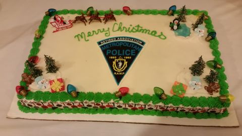 1991 Ford LTD Crown Victoria - Photo of a Merry Christmas sheet cake with a Metropolitan Police Retired Association crest, not a technical document.
