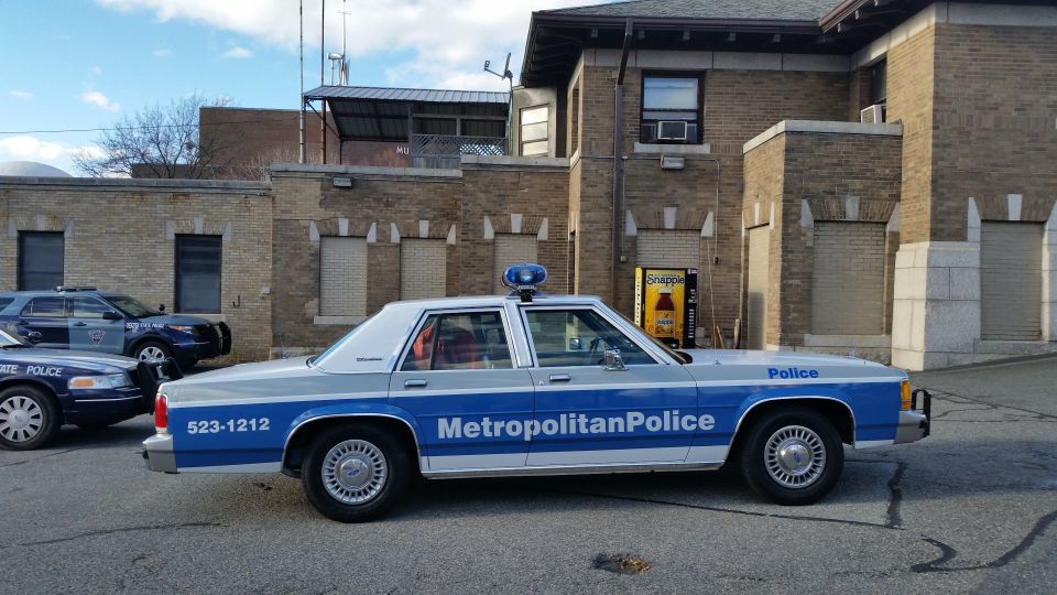 Side profile of a Metropolitan Police Ford Crown Victoria parked at a station