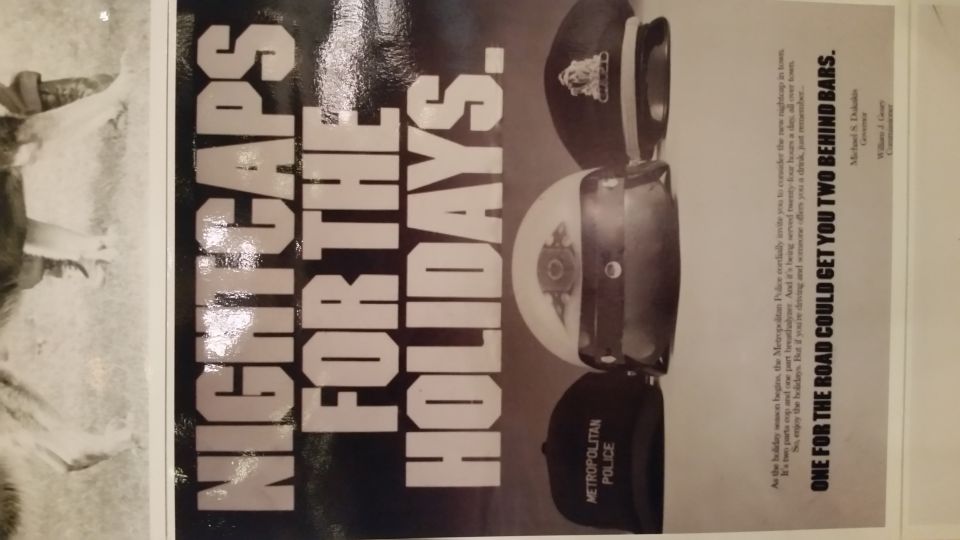 Public-service poster reading Nightcaps for the Holidays with police hats above text