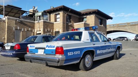 1991 Ford LTD Crown Victoria - Photograph of a Metropolitan Police Ford Crown Victoria patrol car parked in a lot, not a technical document.