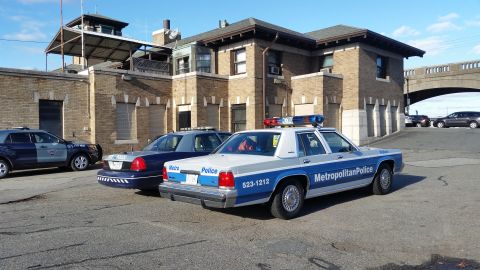 1991 Ford LTD Crown Victoria - Photograph of a Metropolitan Police Ford Crown Victoria patrol car in a station lot, not a technical document.