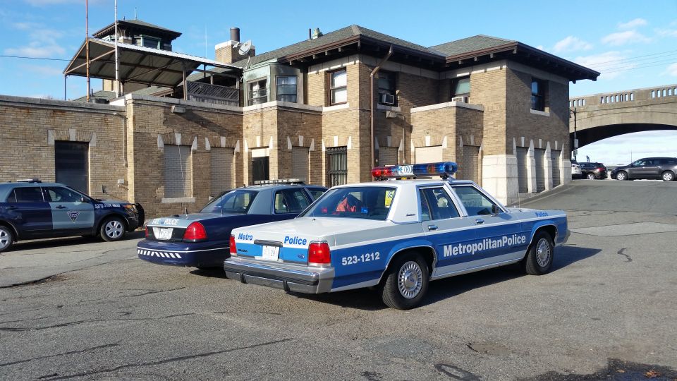 Metropolitan Police Ford Crown Victoria patrol car parked beside other cruisers