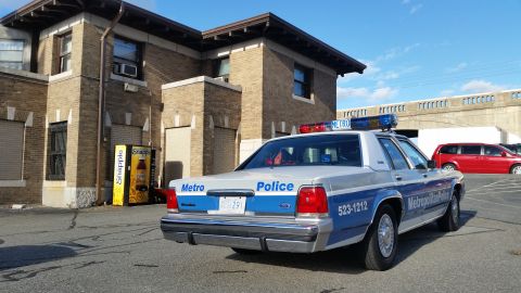 1991 Ford LTD Crown Victoria - Photograph of a Metropolitan Police Ford Crown Victoria patrol car parked in a lot, not a technical document.