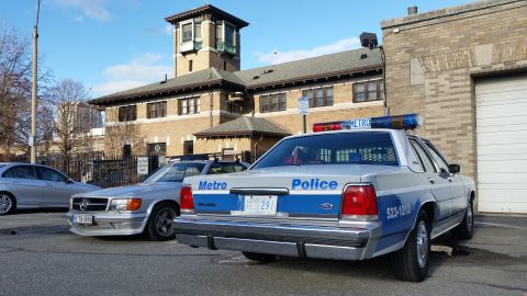 1991 Ford LTD Crown Victoria - Photograph of a Metropolitan Police Ford Crown Victoria patrol car at a station lot, not a technical document.