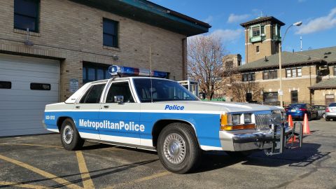 1991 Ford LTD Crown Victoria - This 1991 Ford Crown Victoria police car is parked outside a station with a light bar on top.