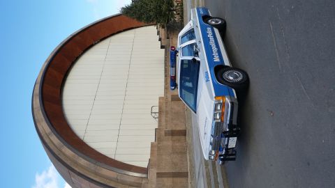 1991 Ford LTD Crown Victoria - Police car with 'Metropolitan Police' text on the side is parked outside a modern building.
