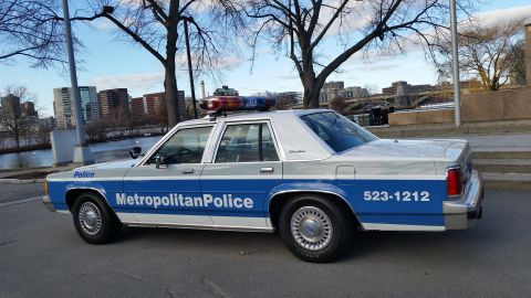 1991 Ford LTD Crown Victoria - A police car with "Metropolitan Police" markings and a light bar is parked outdoors.