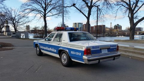 1991 Ford LTD Crown Victoria - Metropolitan Police Crown Victoria, marked with 523-1212, parked near a waterfront.