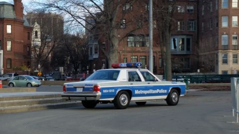 1991 Ford LTD Crown Victoria - A police car with 'Metropolitan Police' written on its side is parked on a street.