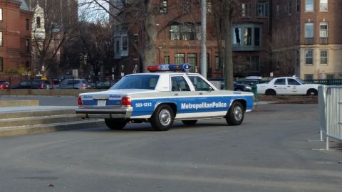 1991 Ford LTD Crown Victoria - A 1991 Ford Crown Victoria police car is parked on the street, with "Metropolitan Police" written on its side.