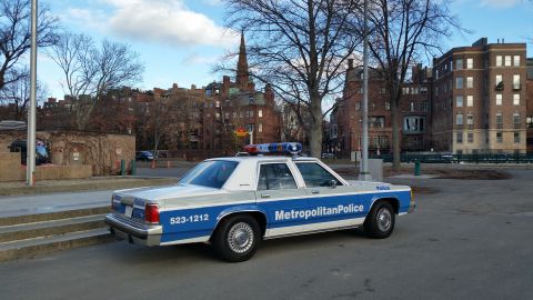 1991 Ford LTD Crown Victoria - Side view of a 1991 Ford Crown Victoria police car parked on a city street.