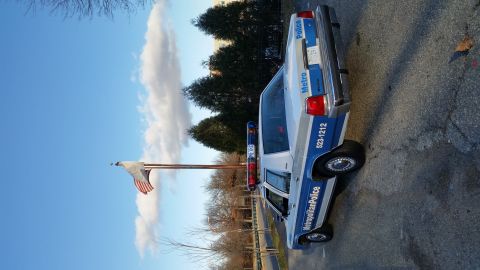 1991 Ford LTD Crown Victoria - A 1991 Ford Crown Victoria police car, marked "Metropolitan Police", is seen from the rear three-quarter angle.