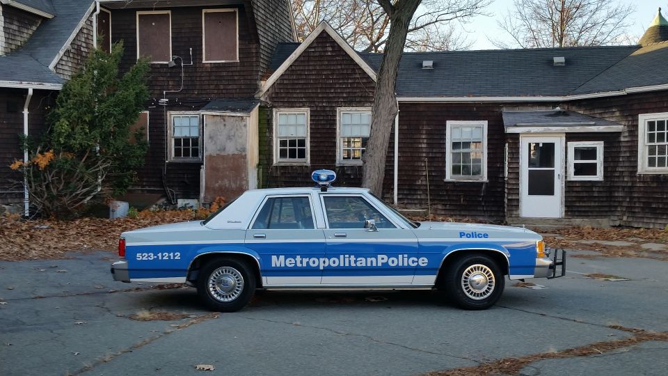 Side view of a 1991 Ford Crown Victoria police car with 'Metropolitan Police' text