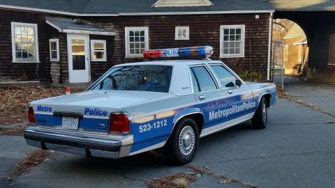 1991 Ford LTD Crown Victoria - 3/4 rear view of a blue-and-silver Ford LTD Crown Victoria marked 'Metropolitan Police' / 'Metro Police' with 523-1212 on the quarter panel…