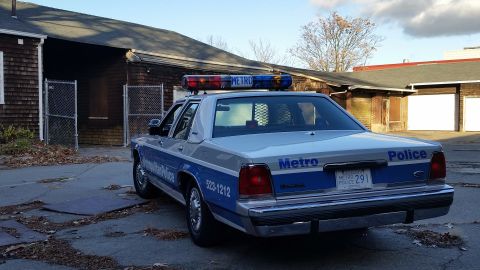 1991 Ford LTD Crown Victoria - This 1991 Ford Crown Victoria police car is parked in front of a weathered building.
