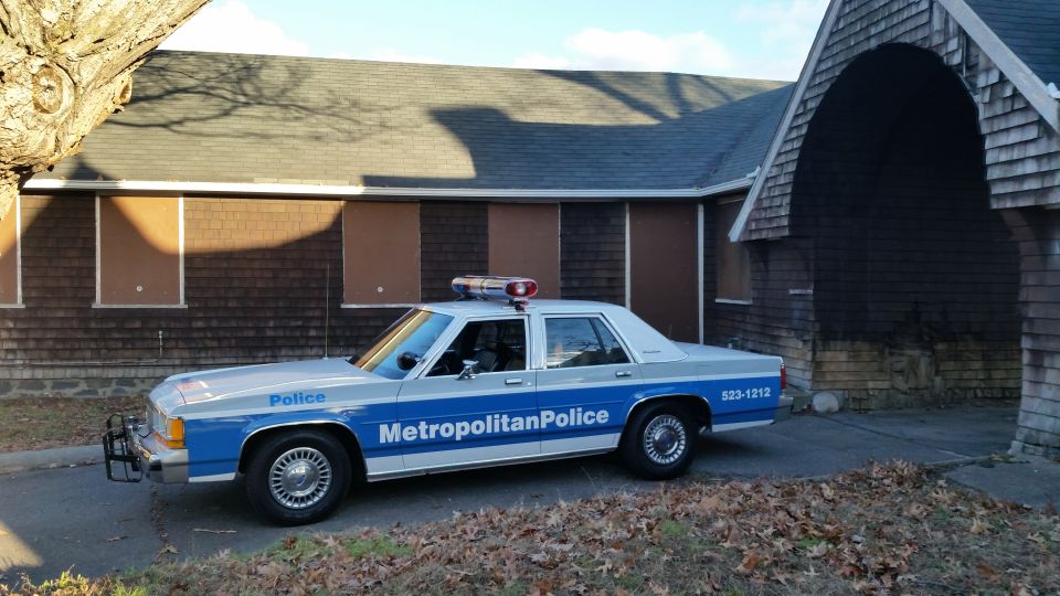 Side view of a 1991 Ford Crown Victoria police car with 'Metropolitan Police' on the door