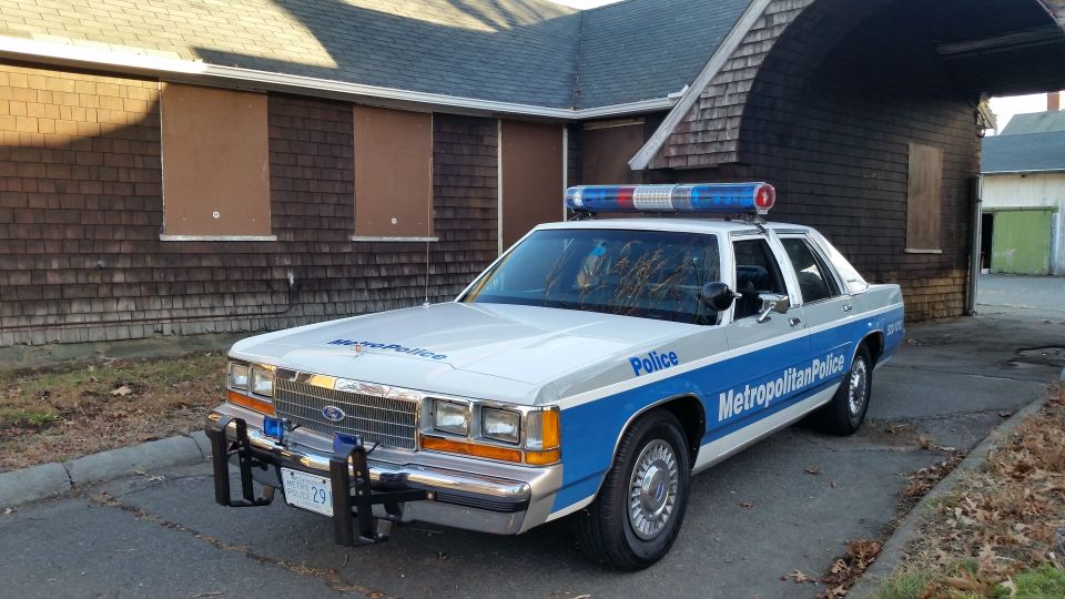 White and blue police car, 1991 Ford Crown Victoria, with light bar and push bumper