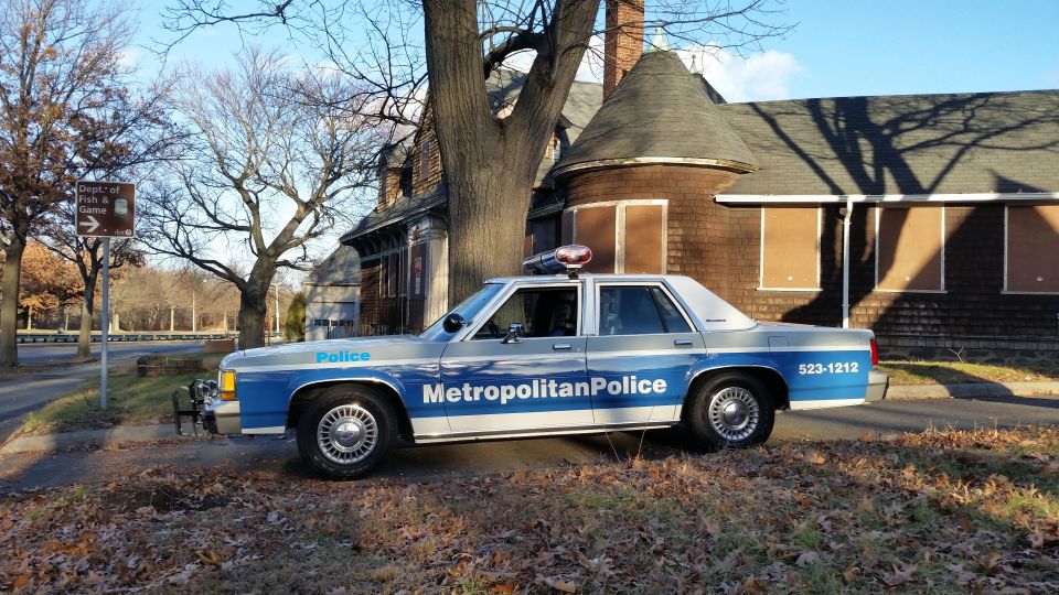 Side view of a 1991 Ford Crown Victoria police car with 'Metropolitan Police' text