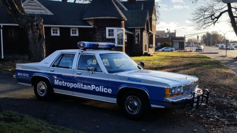 1991 Ford LTD Crown Victoria - A 1991 Ford Crown Victoria police car is parked on a residential street with a light bar on the roof.