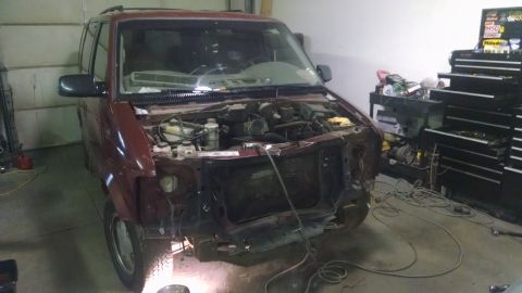 2000 Chevrolet Astro - This Chevrolet Astro van is in a garage with its front end disassembled for repairs.