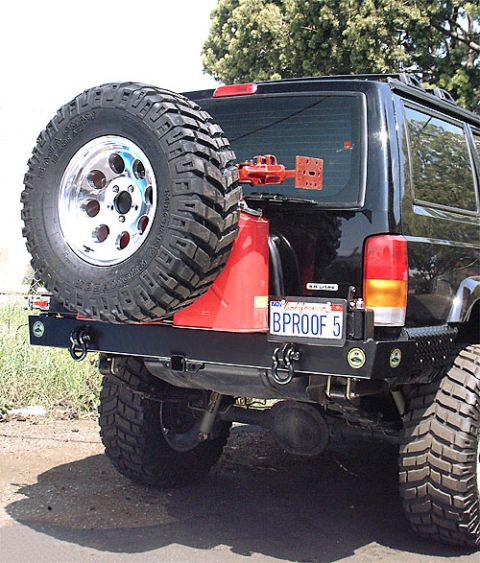 1990 Ford Bronco - Rear view of an SUV showing a custom bumper, spare tire, and jerry can mount.