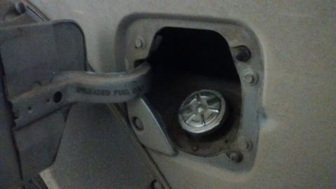 1994 Ford Bronco - Fuel filler door and cap detail. The flap has 'UNLEADED FUEL ONLY' text visible.