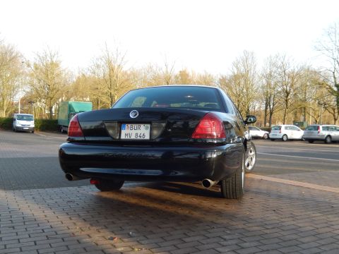 2003 Mercury Marauder - Rear view of a black 2003 Mercury Marauder sedan parked on a brick surface.