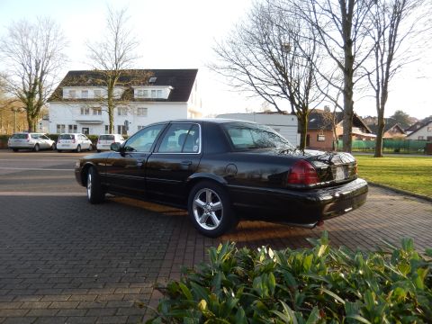 2003 Mercury Marauder - A black 2003 Mercury Marauder is parked on a brick driveway in front of a white building.