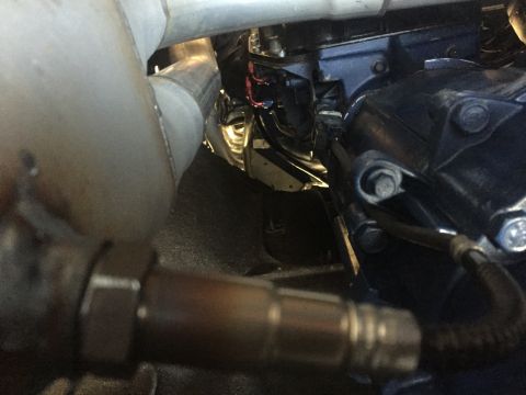 1982 Ford Bronco - Close-up view of engine components, including an exhaust pipe and oxygen sensor.