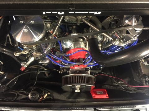 1982 Ford Bronco - This is a detailed, high-angle view of a modified V8 engine bay, likely from a classic American vehicle. Visible components include a large…