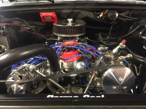 1982 Ford Bronco - Close-up view of a modified V8 engine bay, featuring a red MSD ignition box, chrome air cleaner, and blue spark plug wires.