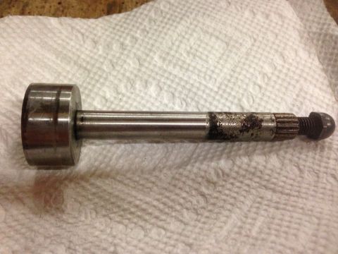 1979 Ford Bronco - A metal shaft with a cylindrical head on the left and a threaded end with a nut and splines on the right is resting on a white paper towel.
