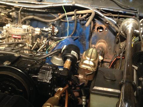 1979 Ford Bronco - Close-up view of an engine bay, showing the carburetor and brake booster assembly.