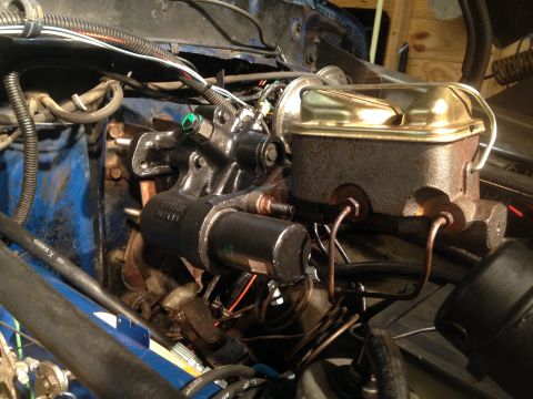 1979 Ford Bronco - Close-up of a hydroboost brake booster and master cylinder assembly, showing brake lines and wiring.