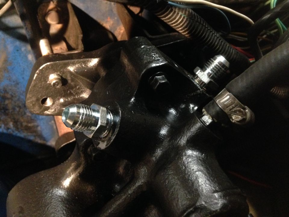 Black hydroboost conversion part with silver fittings and hose clamp