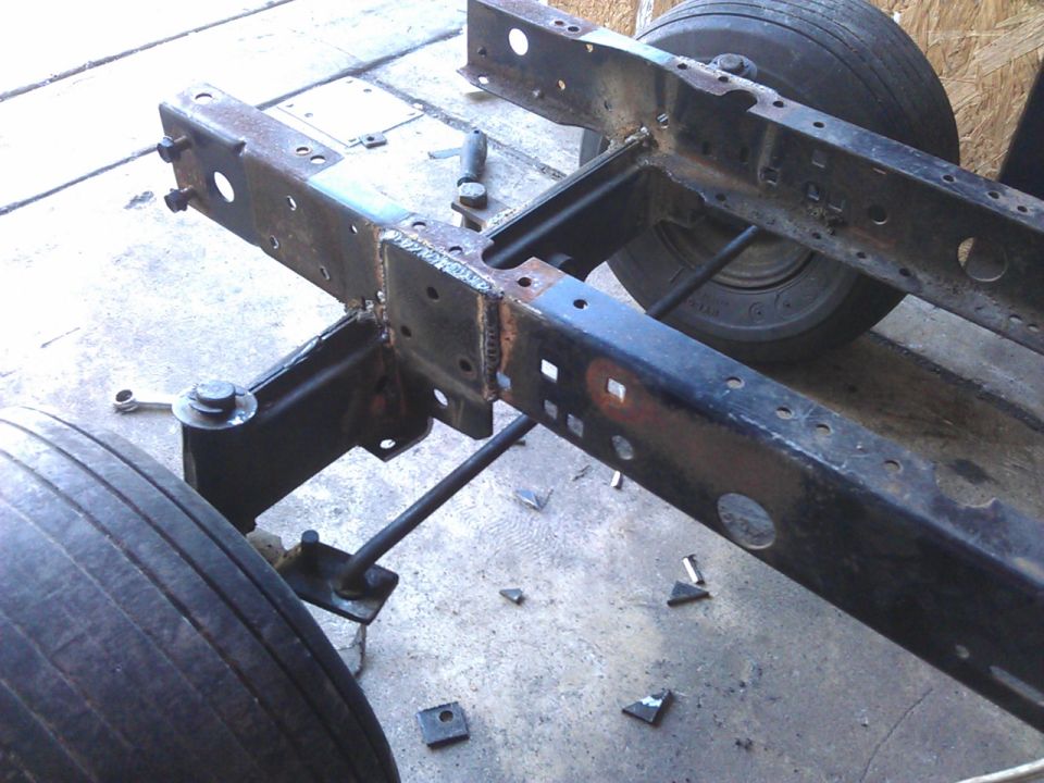 Rusted metal frame and tires of a yard cart