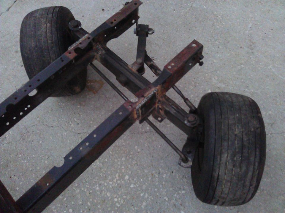 Vehicle frame with two wheels and suspension components visible