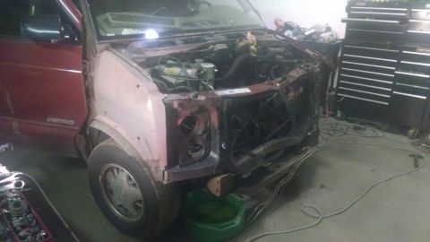 2000 Chevrolet Astro - This Chevrolet Astro van is in a garage with its front end disassembled for repairs.