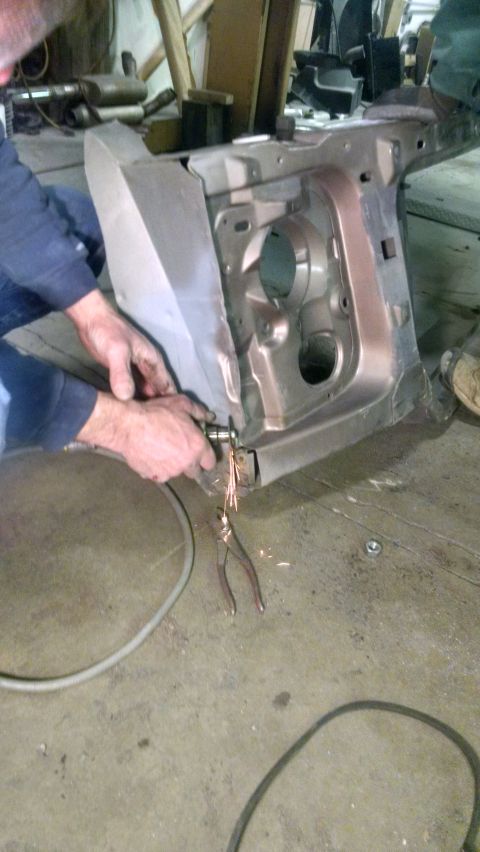 2000 Chevrolet Astro - Metal fabrication work on a vehicle chassis in a workshop.