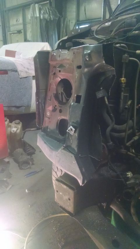 2000 Chevrolet Astro - The front fender and headlight area of a 2000 Chevrolet Astro van is shown, likely during repairs or restoration.