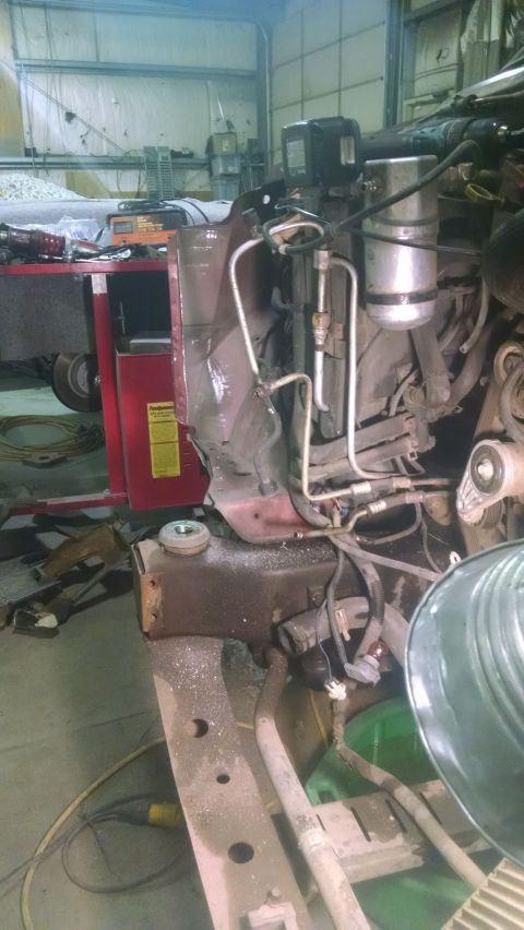 2000 Chevrolet Astro - The engine compartment shows damage to the front fender area, with various hoses and components visible. A Supermotors.net logo is present…