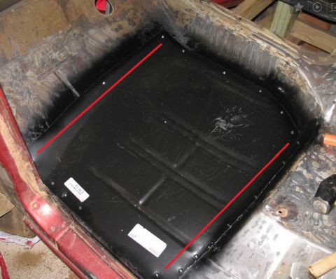 1994 Ford Bronco - Photograph of a stripped cab floor pan with red measurement lines annotated on it.