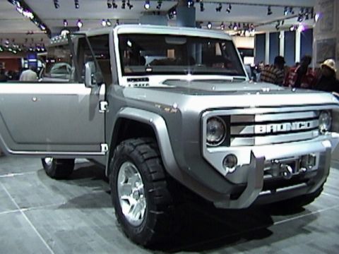 1995 Ford Bronco - This silver Ford Bronco concept vehicle is displayed with its driver's door open, revealing its interior and large tires.