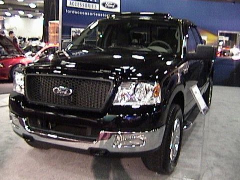 1995 Ford Bronco - Front view of a black Ford F-150 pickup truck, likely from the 2004 model year, displayed at an auto show.