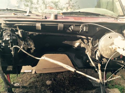 1994 Ford Bronco - The engine bay of a classic vehicle, likely a Ford Bronco, is shown with the hood removed. Various engine components, wiring, and the firew…