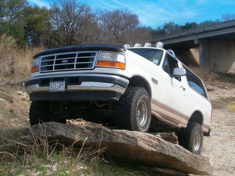 1996 Ford Bronco - 1996 Ford Bronco navigating rocky terrain under a bridge.