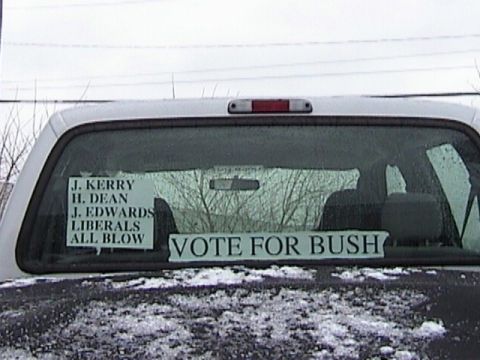 2004 Ford F-250 - Political stickers are displayed on the rear window of a truck during winter.